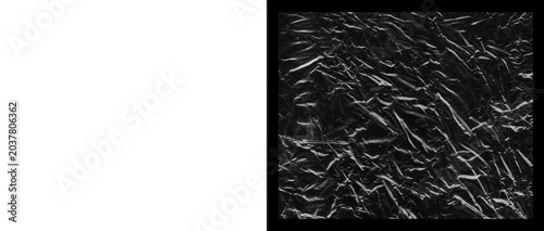 Crumpled black paper texture, wrinkled dark foil surface background, abstract creased charcoal material with dramatic highlights and shadows