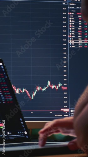 Close up: businessman hands working on laptop or computer keyboard for trading or stock market investing. Male investor sells and buys Bitcoin and crypto coins. Trader chart on terminal monitor.