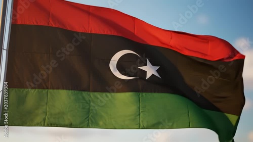 Libyan flag waving in sky