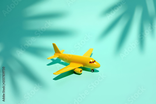 Mini Airplane On Bright Background. Travel Concept Minimal Scene. Summer Vacation Idea.