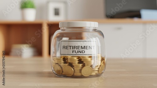 Retirement Fund Savings Jar With Coins On Wooden Desk In Office