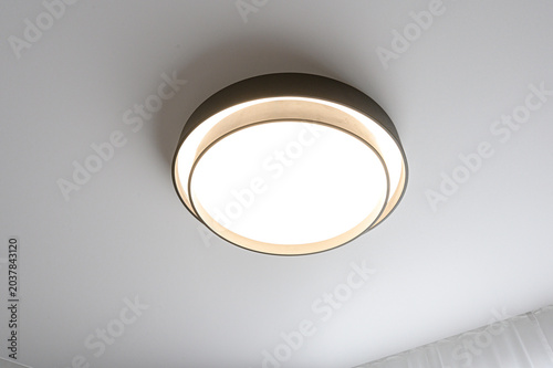Bild auf Leinwand A modern flush-mount ceiling light with a matte black outer ring and concentric