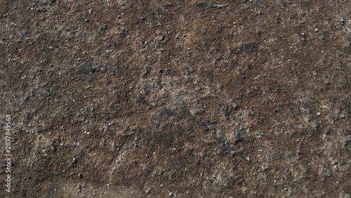 Fotografía Dry ground texture with cracked soil and small stones full frame