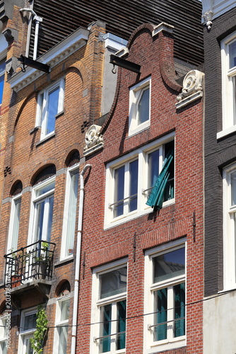 Amsterdam Haarlemmerdijk Brick House Facade with Clock Gable and Green Curtain, Netherlands