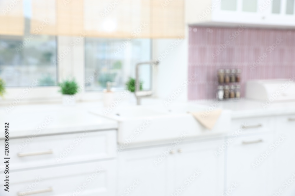 Fototapeta premium Blurred view of stylish kitchen interior with sink near window
