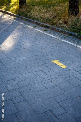Yellow arrow indicating the Way to Santiago de Compostela to pilgrims on their journey in search of Faith