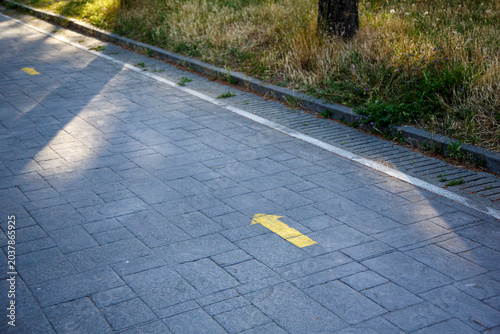 Yellow arrow indicating the Way to Santiago de Compostela to pilgrims on their journey in search of Faith