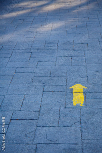 Yellow arrow indicating the Way to Santiago de Compostela to pilgrims on their journey in search of Faith