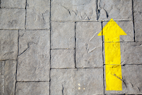 Tableau sur toile Yellow arrow indicating the Way to Santiago de Compostela to pilgrims on their j