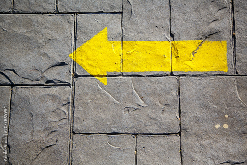 Yellow arrow indicating the Way to Santiago de Compostela to pilgrims on their journey in search of Faith