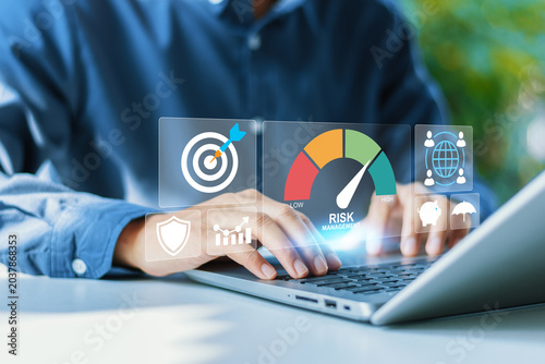 Professional analyzing risk management score on computer dashboard for enterprise threat mitigation, investment portfolio balance, security compliance, and strategic defense concepts.