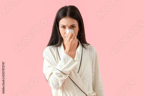 Young woman with nose patch...