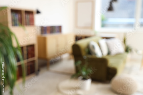 Blurred view of green sofa ...