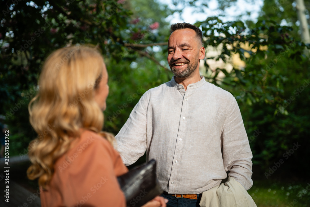 Obraz premium Happy man laughing talking with woman in park