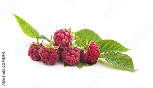 Fresh sweet raspberries with green leaves isolated on a white background.