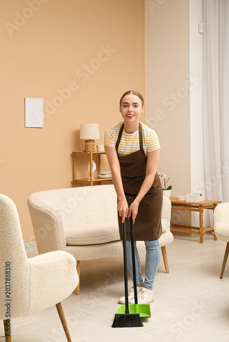 Young woman cleaning floor ...