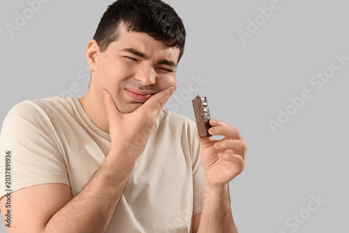Young man with candy bar su...