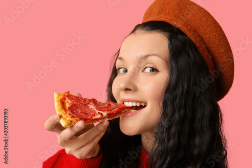 Happy young woman eating ta...