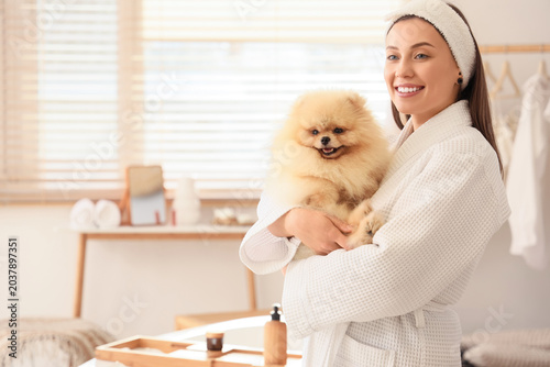 Young woman with cute Pomer...