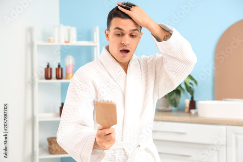 Shocked young man with hair...