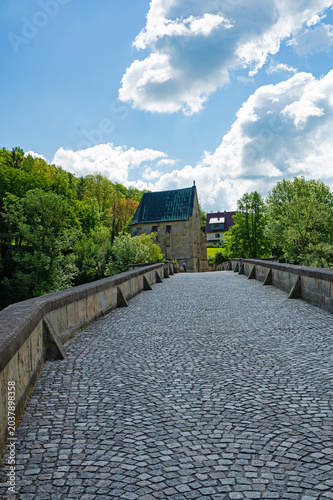 old stone bridge over the river Werra and liborius chapel near Creuzburg in Thuringia in Germany