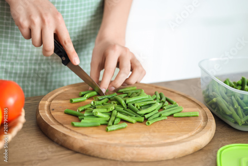 Woman cutting green beans f...