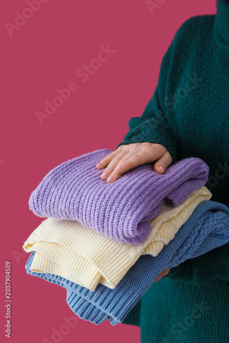 Woman holding stack of diff...