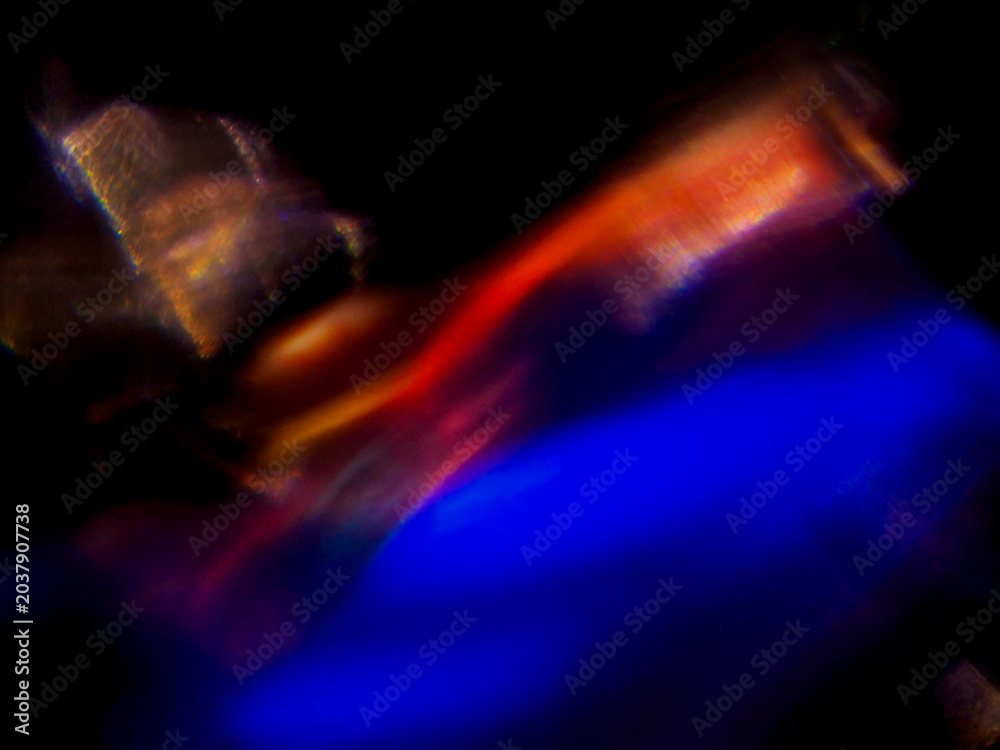 Fototapeta premium Blue glow pulses softly against dark void. Light swirls in organic, abstract motion. Faint hints of form suggest hidden energy. Perfect for futuristic or mysterious themes