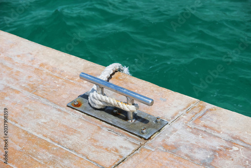 Mooring cleat on wooden dock.