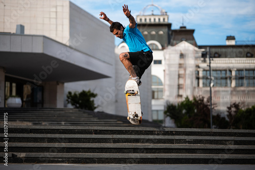 Canvastavla Skateboarder performing ollie trick over stairs in novi sad