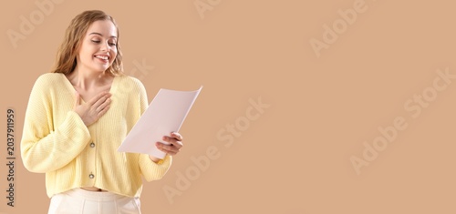 Canvas Print Beautiful actress with movie script on beige background with space for text