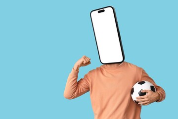 Male sports fan with soccer ball and smartphone instead of his head on blue background