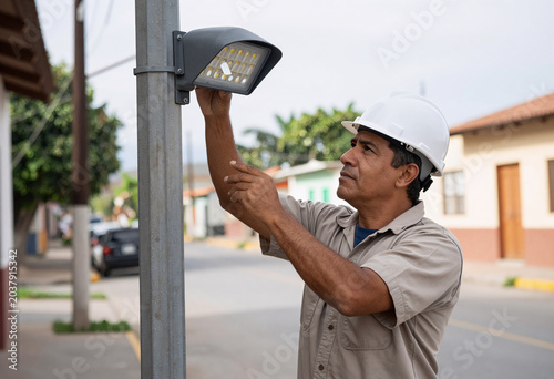 Municipal worker replacing street light with LED