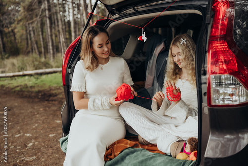 Photography Mother daughter connecting with red thread symbolizing intergenerational healing