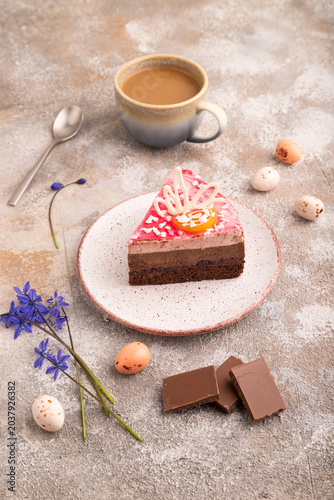Chocolate cake on brown concrete, cup of coffee, side view, close up