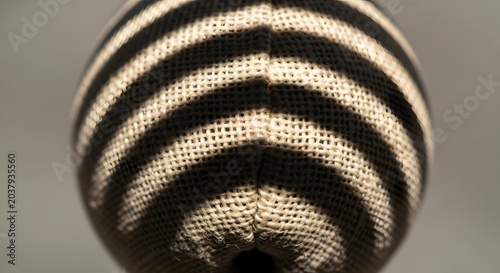 Close up of striped burlap texture on a spherical object with natural lighting