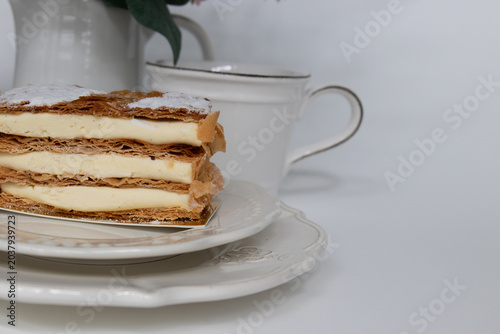 Elegant Vanilla Mille-Feuille Dessert with Floral Background