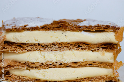 Elegant Vanilla Mille-Feuille Dessert with Floral Background