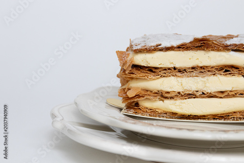 Elegant Vanilla Mille-Feuille Dessert with Floral Background
