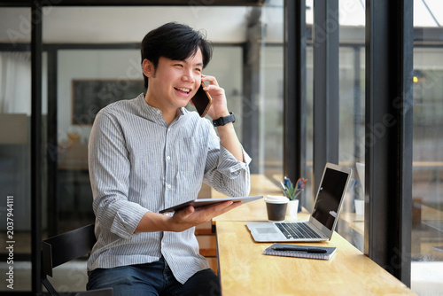 Business people communicate via mobile phones.