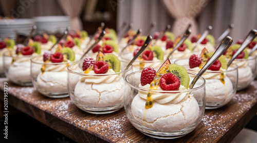 Elegant catering setup of mini Pavlova desserts with fresh berries in glass bowls. Premium hospitality event planning, luxury wedding reception menu and gourmet restaurant food styling concept.
