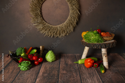Fresh vegetables on a wooden table with a rustic wreath