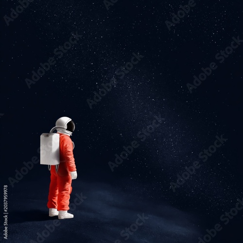 Astronaut Looks at Stars in Dark Space While Standing on Surface