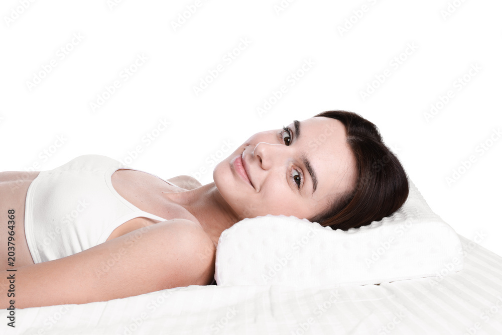 Obraz premium Woman lying on bed with orthopedic pillow against white background