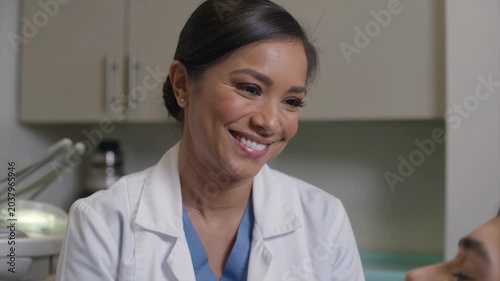 Friendly female doctor talking during consultation