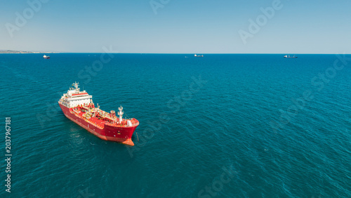 Obraz na plátně Red tanker vessel anchored in turquoise Mediterranean Sea near Catalonia coastli