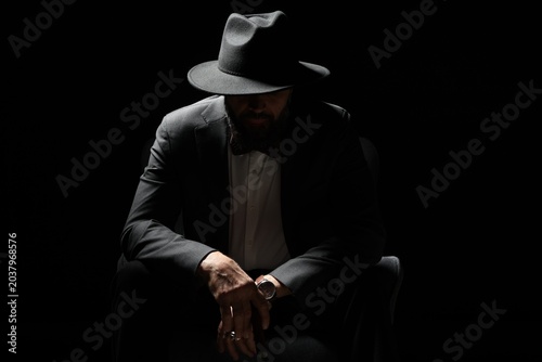 Tableau sur toile Mafia. Man in hat against dark background