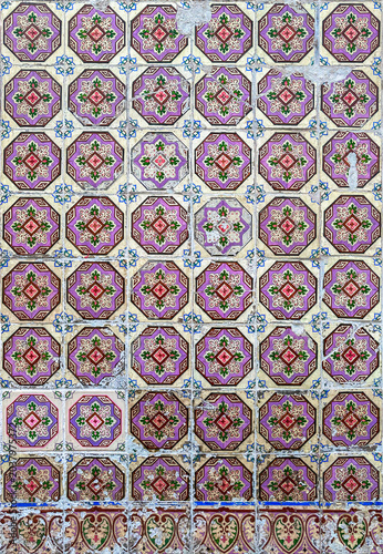 The image showcases a detailed pattern of intricately designed vintage tiles. Each tile features geometric shapes in vibrant colors, creating a harmonious and symmetrical display.