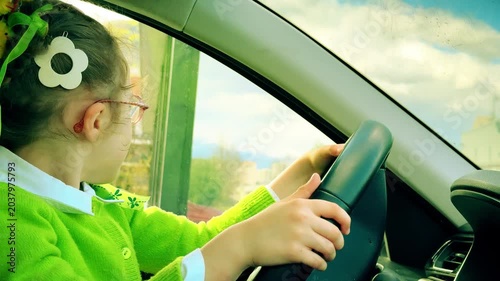 Child Pretending to Drive a Car with Parent Assistance