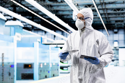 Bild auf Leinwand Overseeing CPU parts production infrastructure, tablet and technician man working in factory, Tracking silicon wafers fabrication lots, device and engineer in microchips manufacturing plant cleanroom